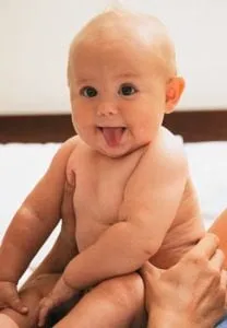 Baby sticking out his tongue, imitating a facial gesture