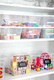 Toys stored in clear bins and baskets on shelves