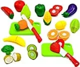 Toy fruits and vegetables with play knives and cutting boards