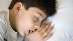 Child sleeping with his thumb in his mouth